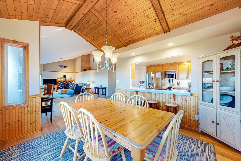 Gather around the large dining table, perfect for family meals and late-night conversations in a charming, rustic setting.