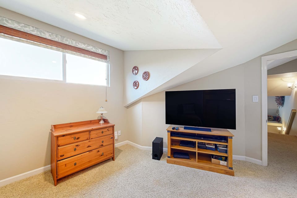 Gather around the entertainment unit in this inviting living space, ideal for movie marathons or game nights with friends.