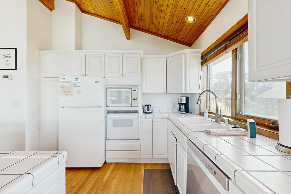 Cook up your favorite meals in this well-equipped kitchen, where culinary dreams come to life amidst a stunning backdrop.