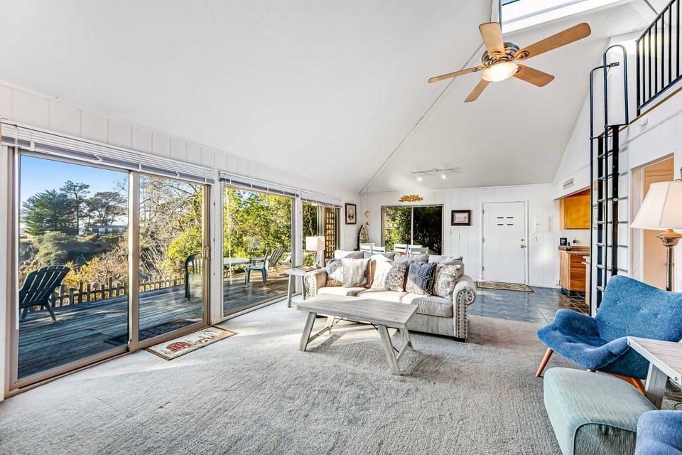Morning light fills this spacious living room, creating an inviting space for relaxation and ocean-inspired tranquility.