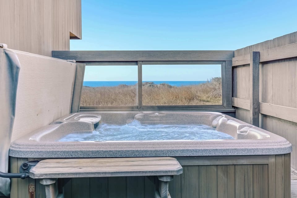 Step into your private hot tub, where you can soak under the stars while enjoying breathtaking ocean views that enhance your relaxation.