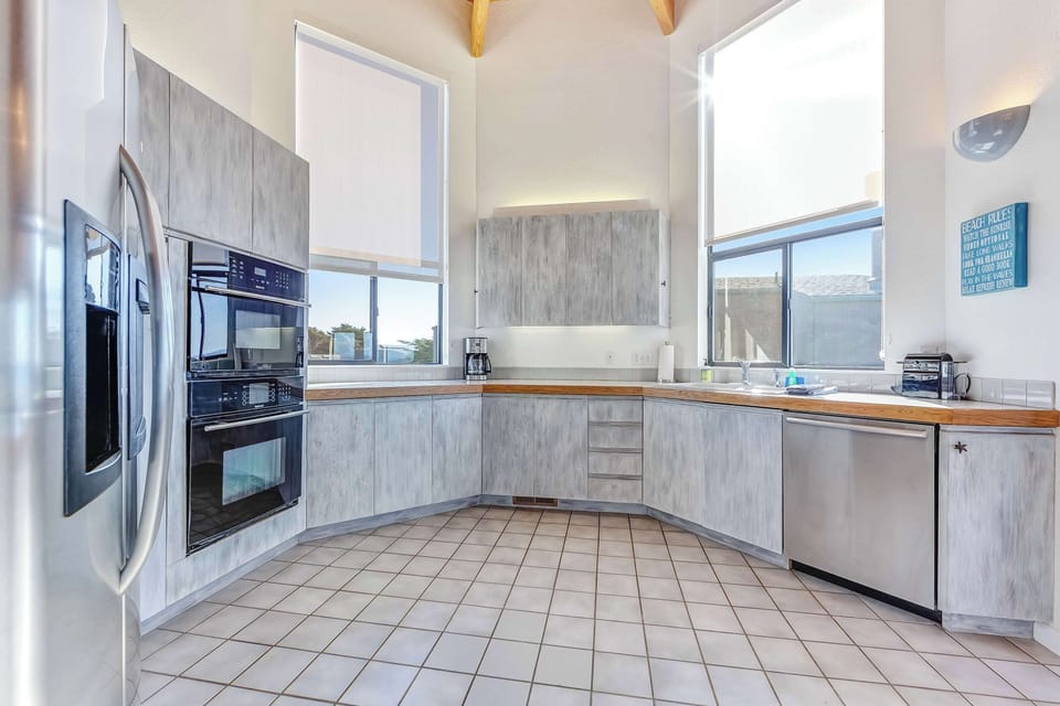 Whip up delicious meals in this modern kitchen, where ocean views inspire culinary adventures and the spacious layout makes it a joy to create.
