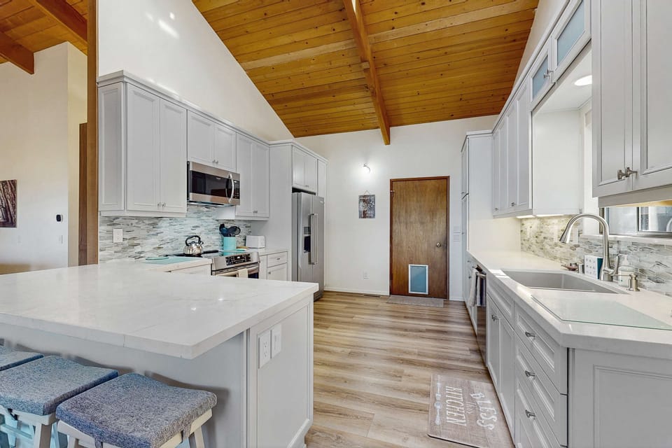 Cook up culinary delights in the modern kitchen, featuring sleek countertops and ample space for creating memorable meals.