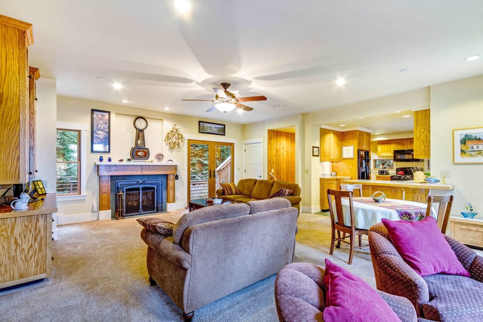 Gather around the fireplace in the spacious living area, ideal for cozy evenings after a day of adventure.