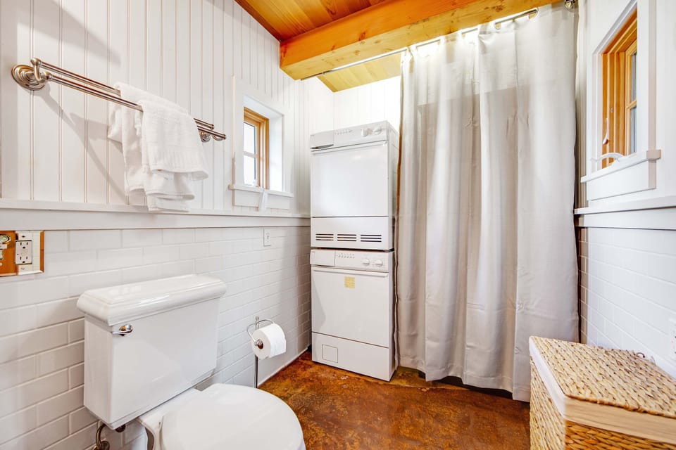 Convenience meets comfort in this thoughtfully designed bathroom, complete with laundry facilities for extended stays.