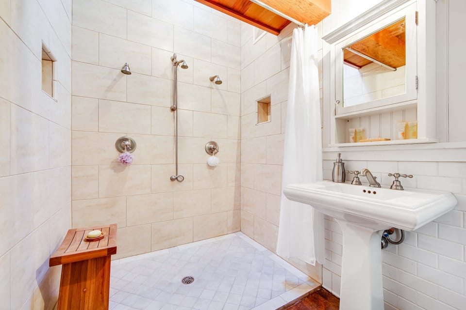 Refresh yourself in this stylish bathroom, featuring an inviting walk-in shower that promises rejuvenating experiences.