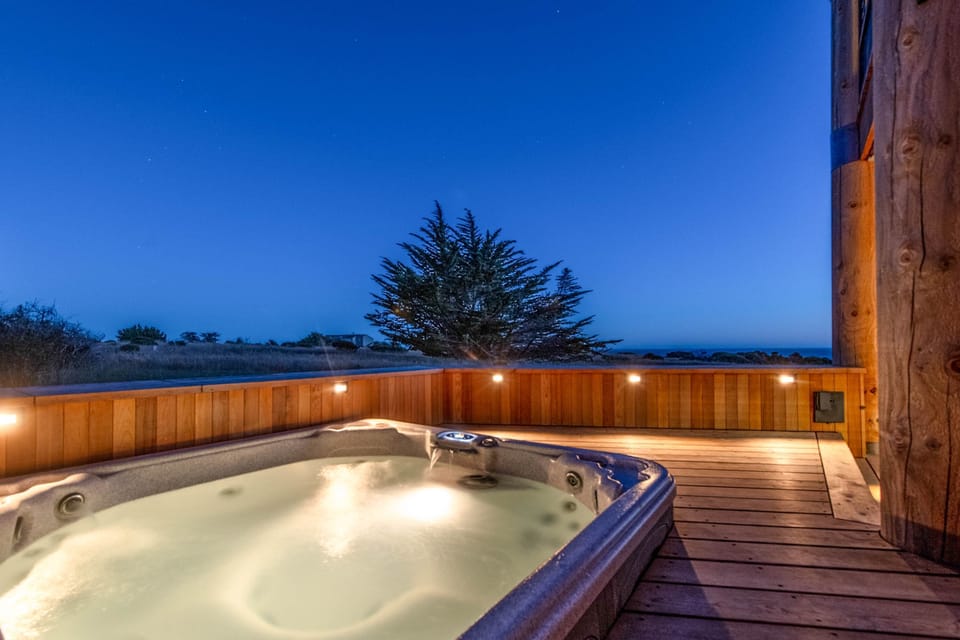 As dusk falls, enjoy the tranquil ambiance of your hot tub retreat, perfect for stargazing and soothing conversations.