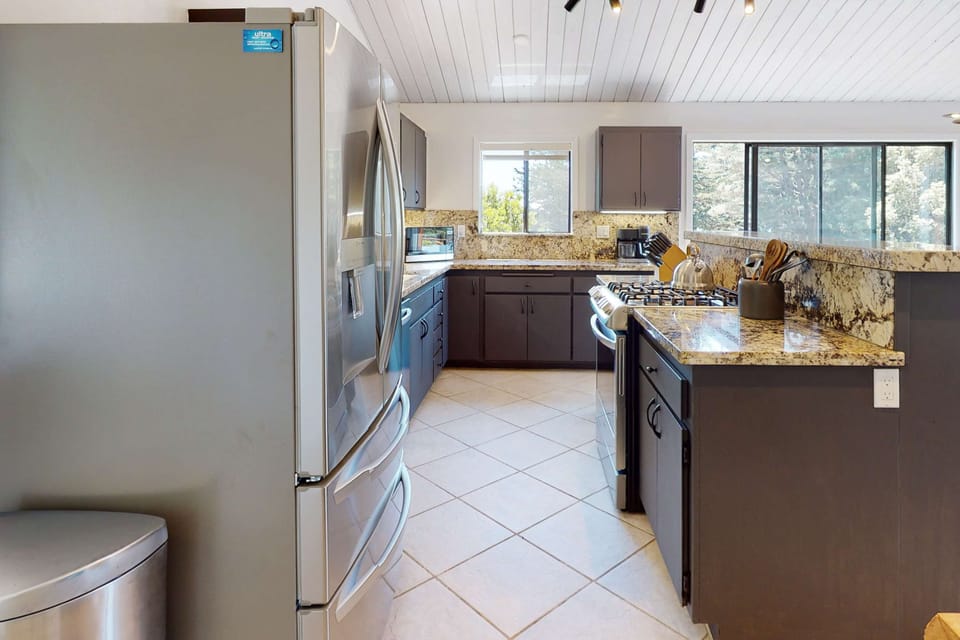 Experience the convenience of this well-equipped kitchen, perfect for preparing snacks before heading out to explore the breathtaking coastline.