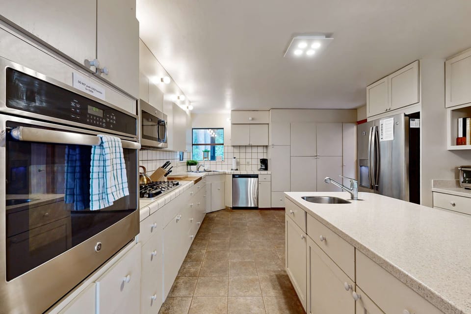 Enjoy seamless meal prep in this spacious kitchen, where natural light and stylish finishes create an inspiring cooking atmosphere.