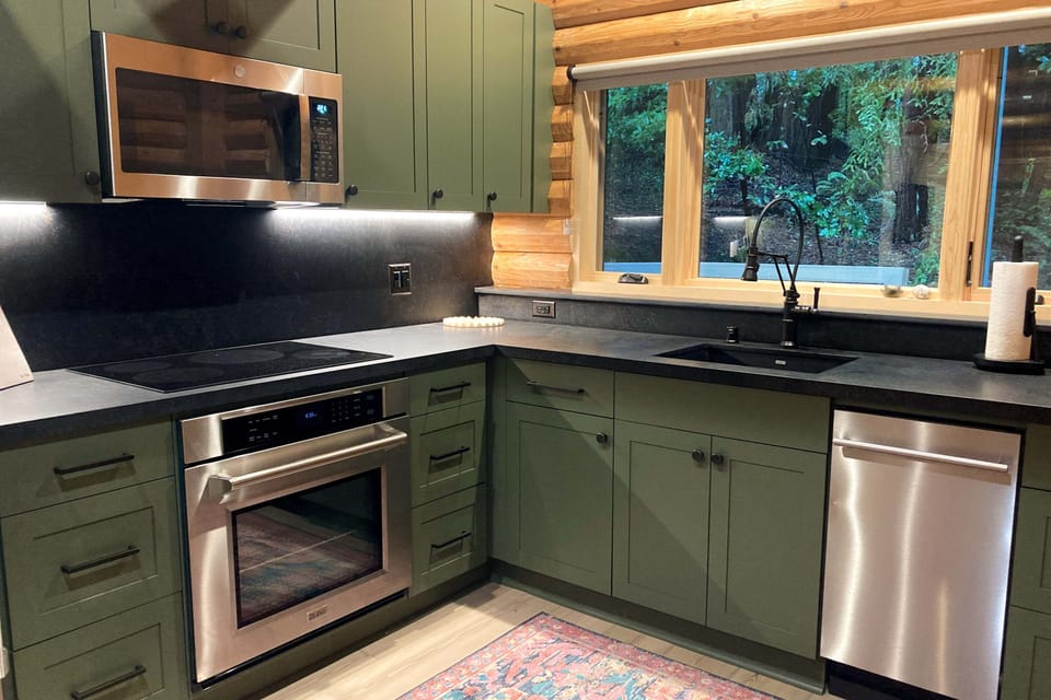 With ample counter space and a view of the serene forest, this kitchen invites culinary creativity and shared moments.