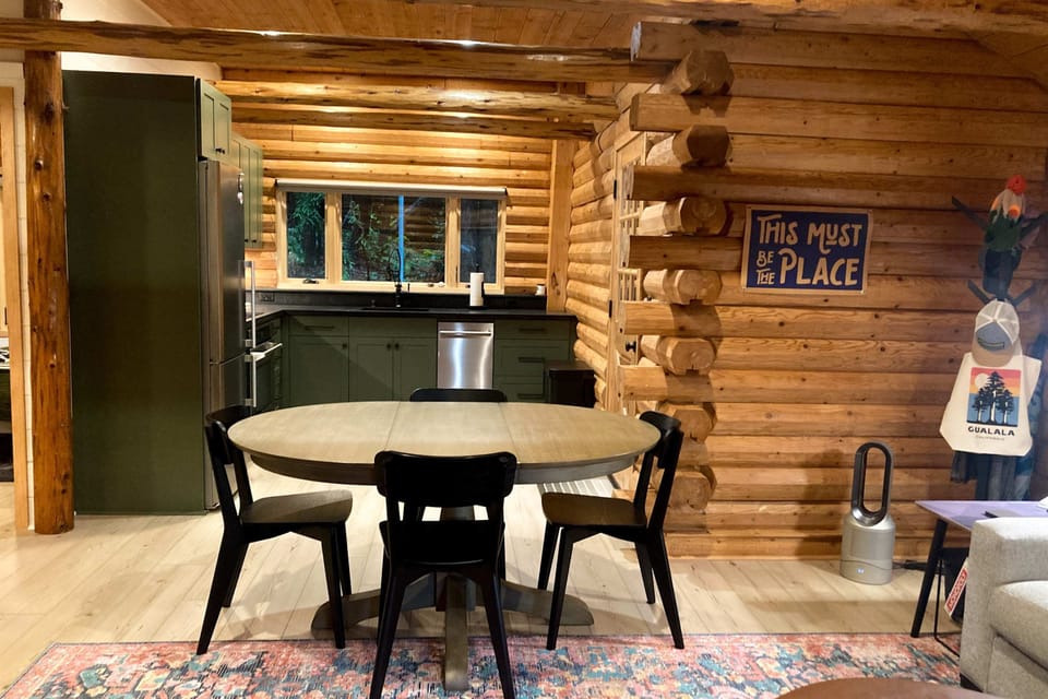 Share meals and laughter in this inviting dining area, where the charm of log cabin living enhances every gathering.