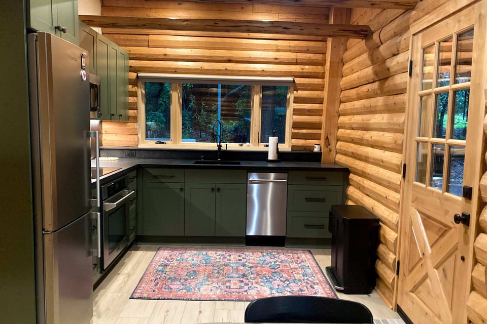 Cook up your favorite meals in this beautifully designed kitchen, where modern appliances meet the warmth of log cabin charm.