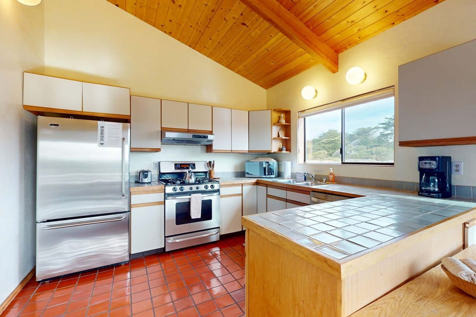 Cook up your favorite meals in the fully equipped kitchen, where modern amenities meet charming rustic details.