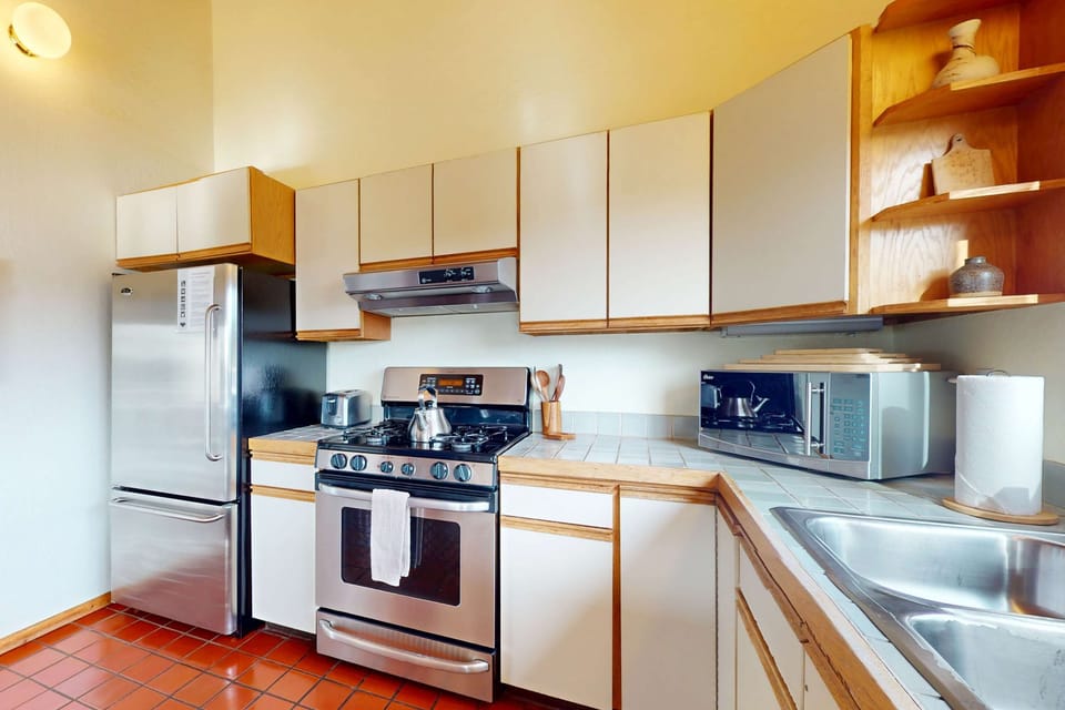 Unleash your inner chef with the fully equipped kitchen, featuring ample counter space and modern appliances to inspire your culinary creations.