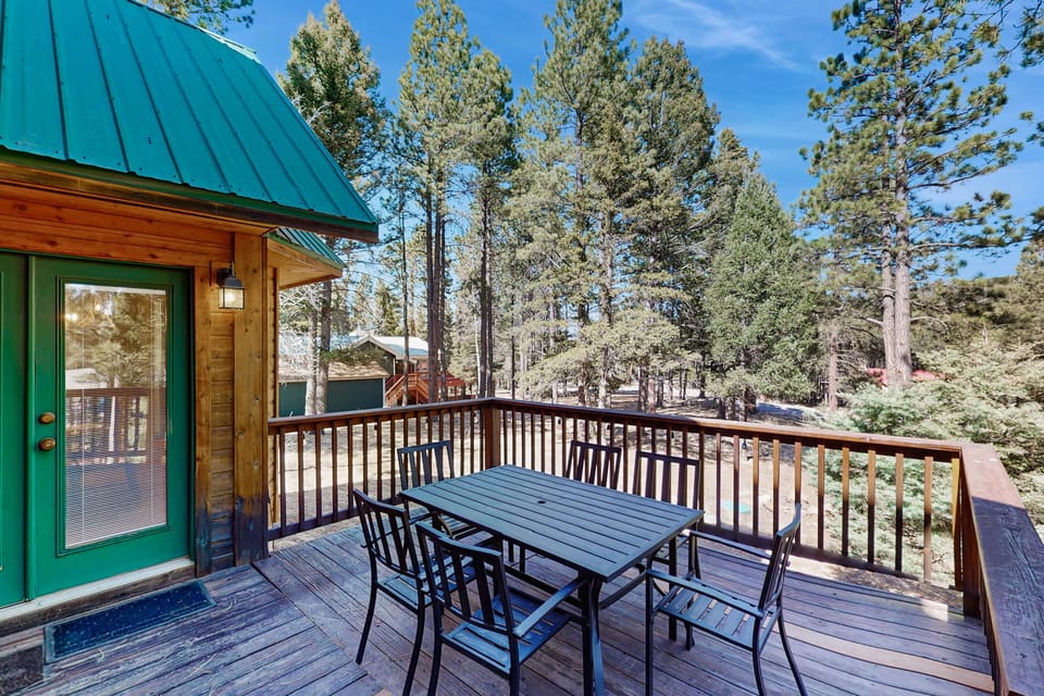 Gather at the deck table with the forest all around