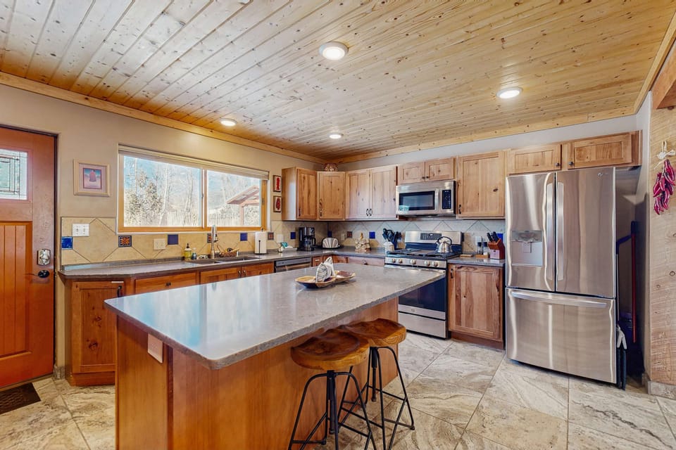Cook together at the island kitchen with stainless steel appliances