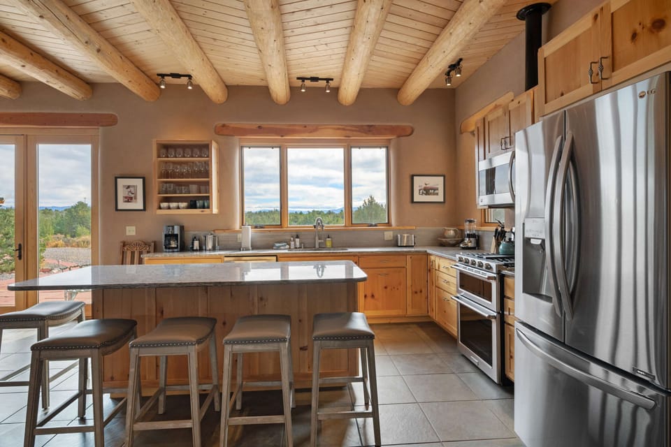 Sip coffee at the island as the kitchen opens to the views