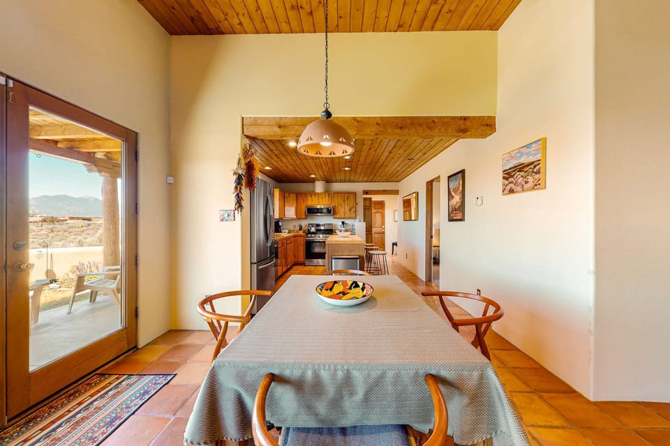 Dine beside French doors that open to the verandah and the views beyond