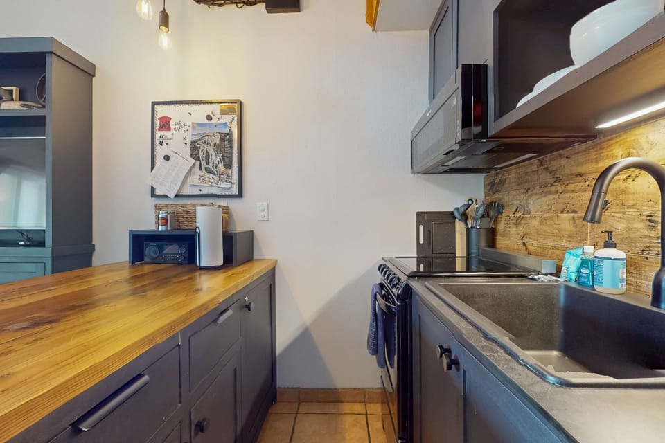 Find ample counter space and wood-accent backsplash in the kitchen