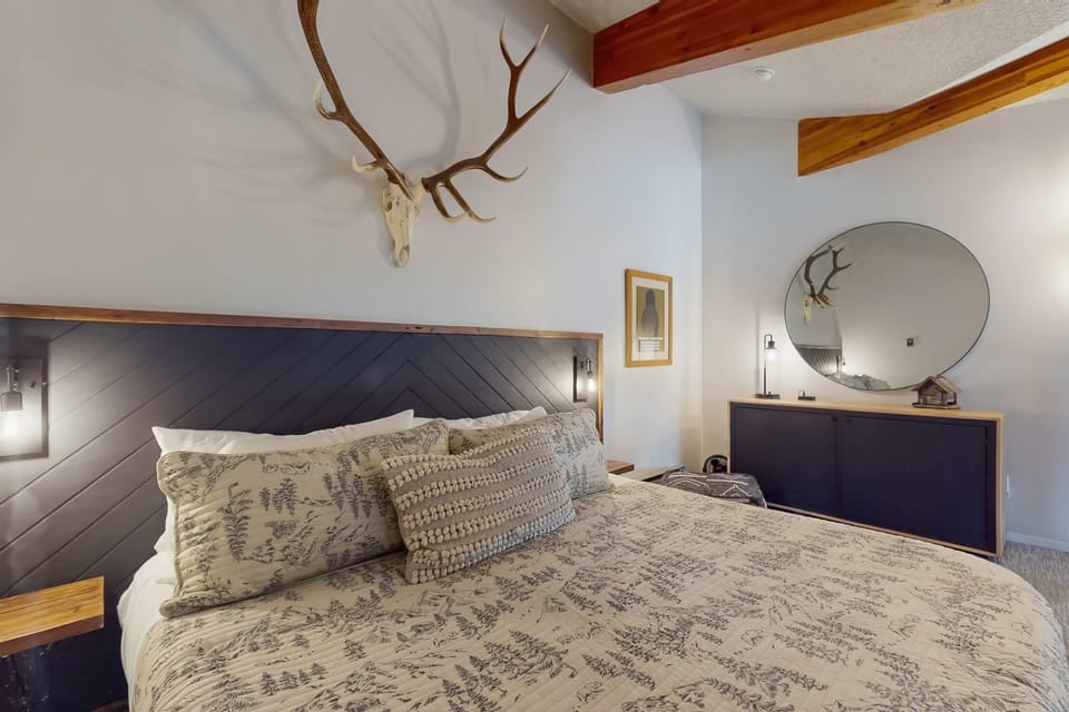 Settle into the cozy loft bedroom with mountain-lodge touches
