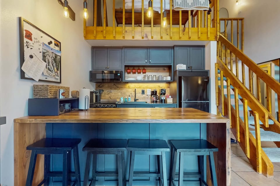 Gather at the butcher-block breakfast bar in the full kitchen