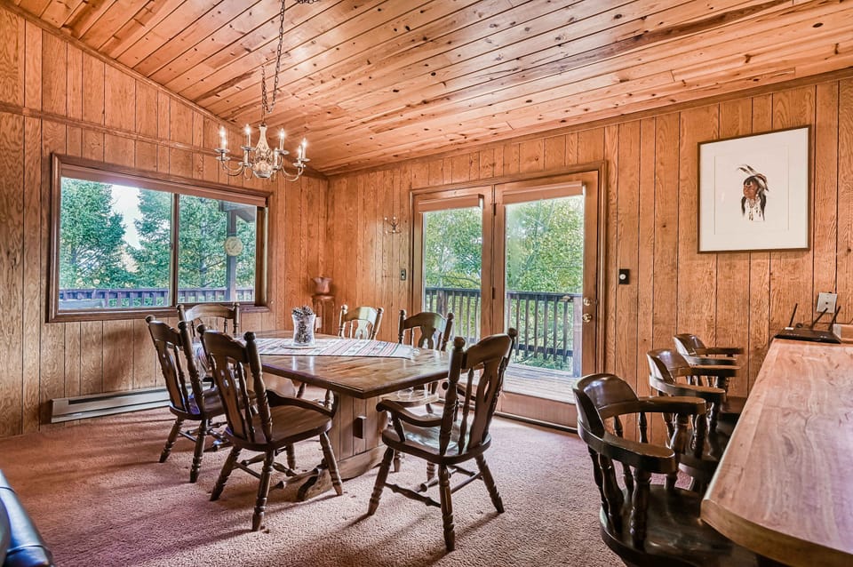 Share meals at a dining table for six beside the forest windows