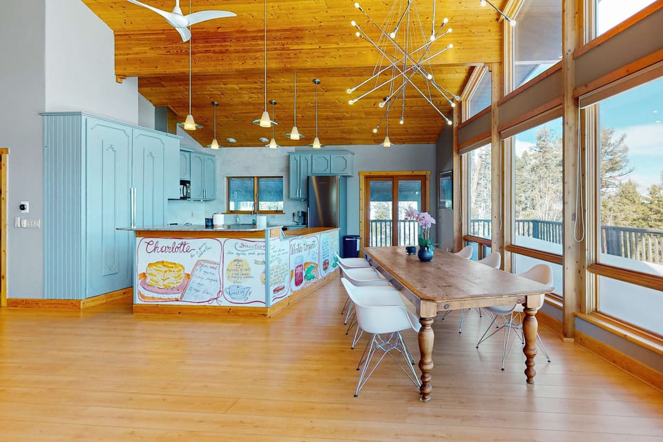 Share meals at the big table beside the windows