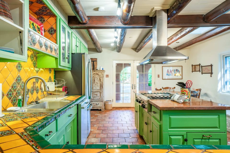 Prep meals on hand-painted tile counters with full-size appliances
