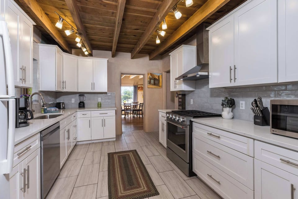 Cook with ease in the full kitchen beneath exposed viga beams