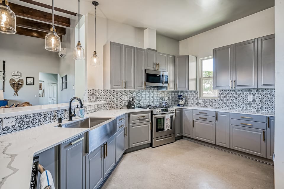 A chef's kitchen with a breakfast bar and stainless appliances