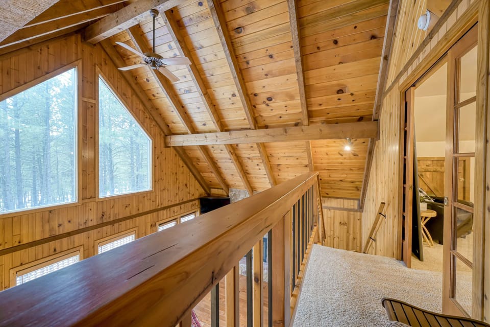 The heart of Coyote Cabin. Gather beneath soaring vaulted ceilings, cozy up by the wood-burning fireplace, and enjoy quality time surrounded by warm mountain charm.