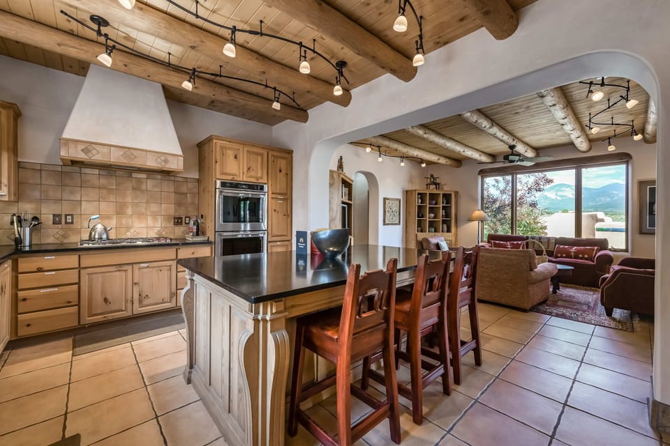 Full kitchen with a prep island and breakfast bar