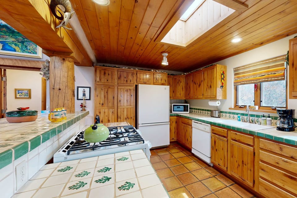 Hand-painted tile counters and a dishwasher keep things easy