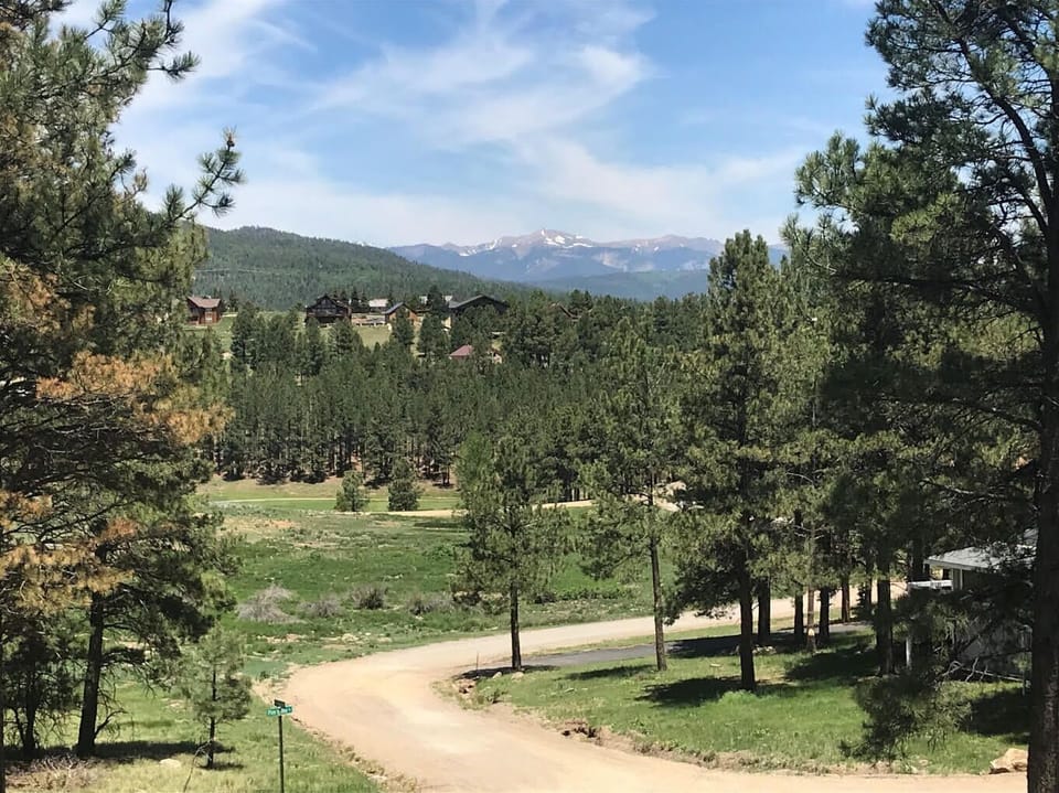 Sweeping mountain views and pines surround the lodge