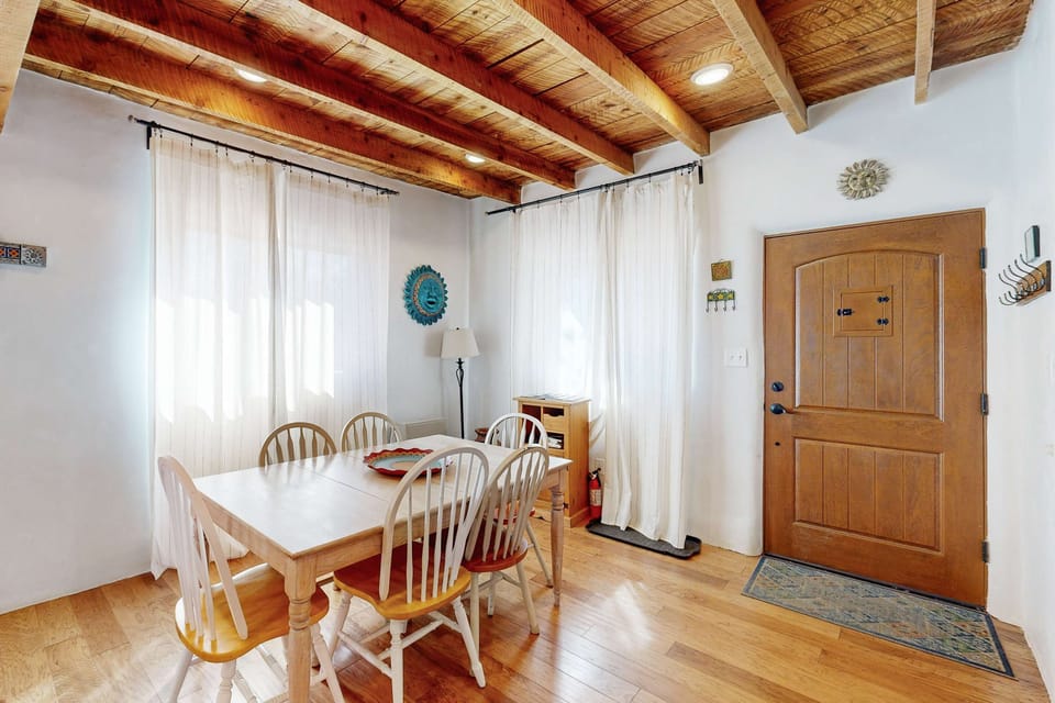 Sunlight pours over the dining table set for six