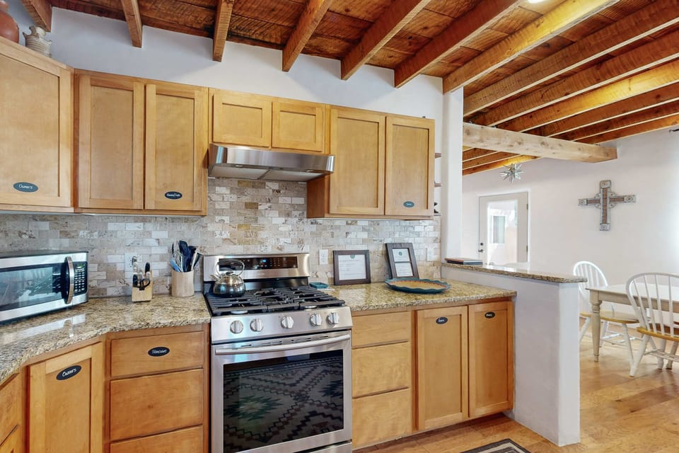 Granite counters and ample prep space open to the dining area