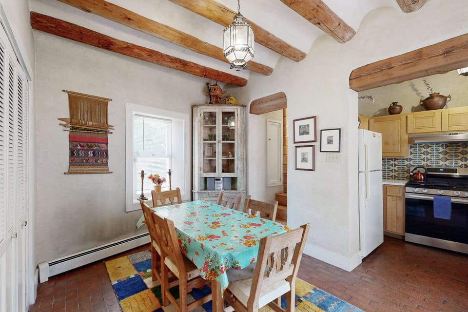 A dining room with antique furnishings and a pendant light