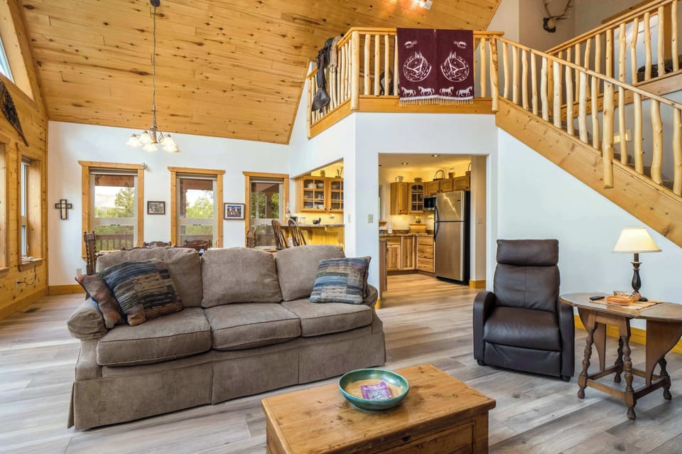Living, dining, and kitchen flow under the open loft