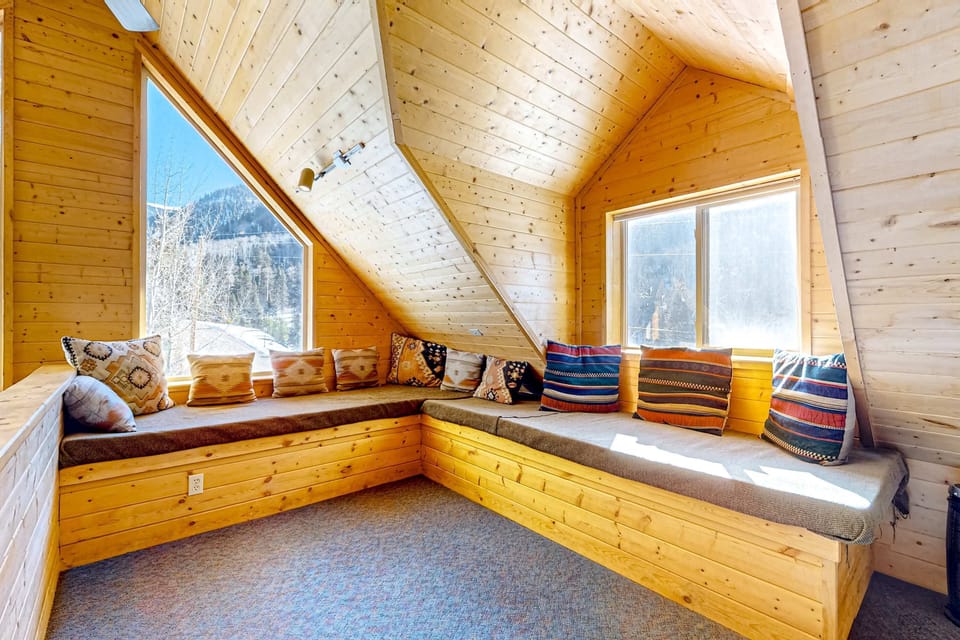 Curl up on the loft window-seat daybeds under the A-frame ceiling