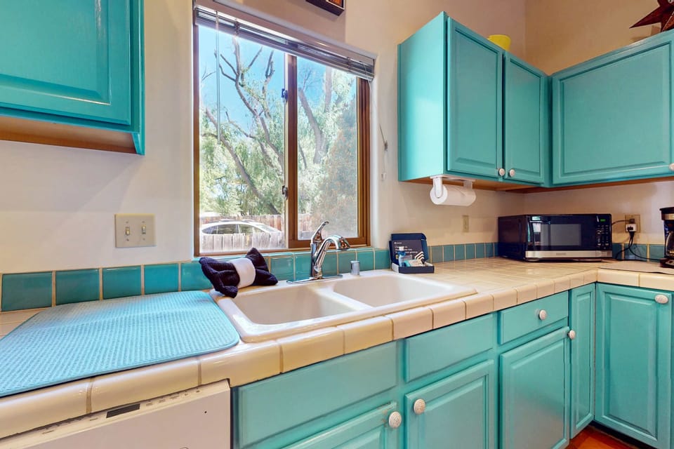 Hand-painted tile and bright cabinetry add Taos charm