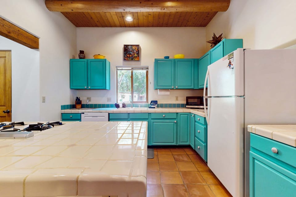 Full kitchen with tile counters and an open island
