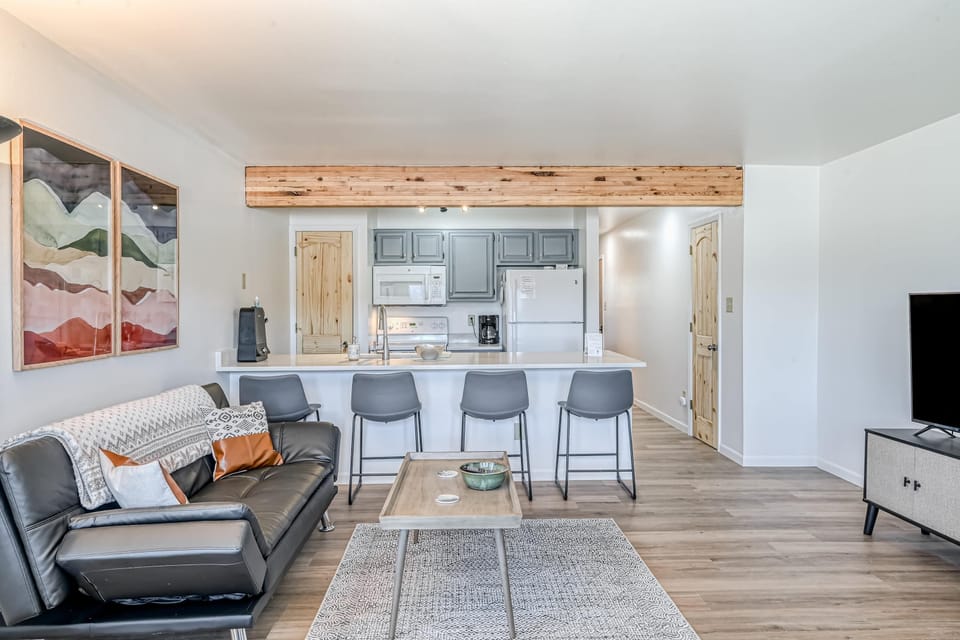 Gather in the open living and kitchen space with a breakfast bar for four