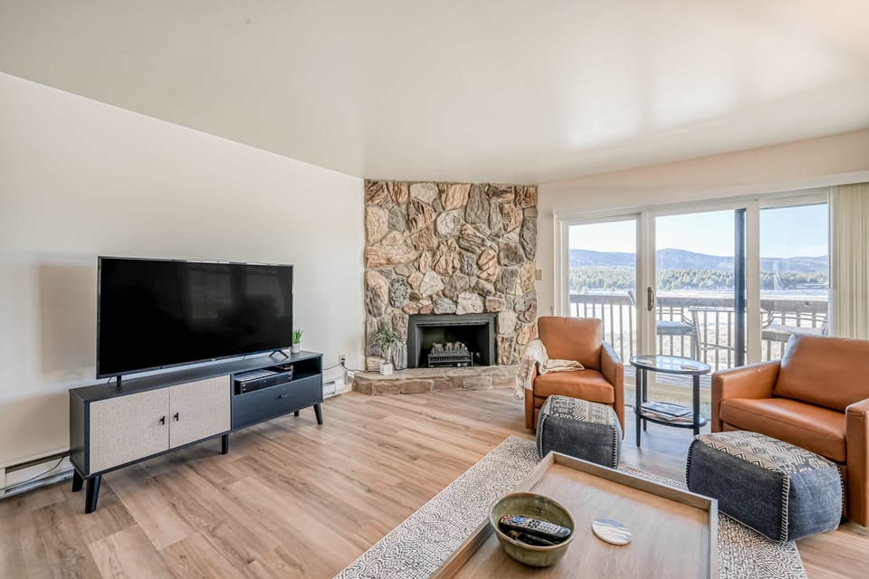 Cozy up by the stone fireplace in the open living room