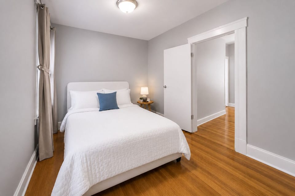 Well-lit bedroom with a comfortable queen bed