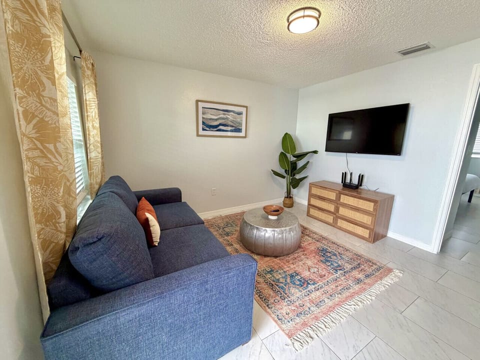 Stylish living room with smart TV and queen sleeper sofa for extra accommodations.