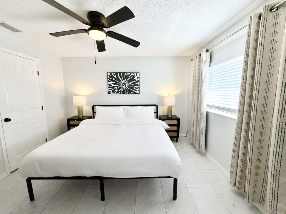 Spacious king suite featuring a plush bed, smart TV, and private ensuite bathroom. Thoughtfully designed with convenient USB charging ports on each nightstand, so everything you need is right within reach.