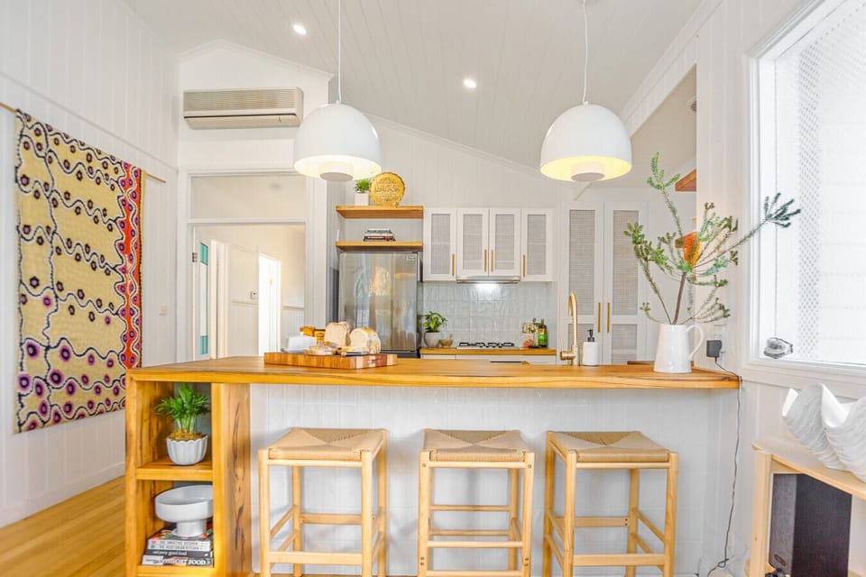 Charming timber kitchen with rattan stools and native botanicals