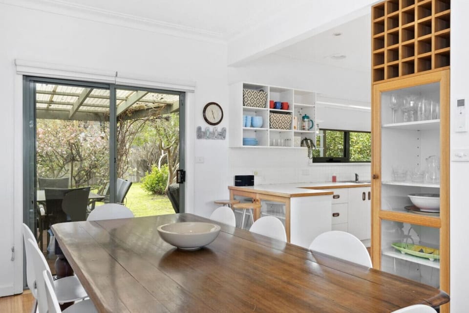 Warm dining space opening to a lovely garden outside