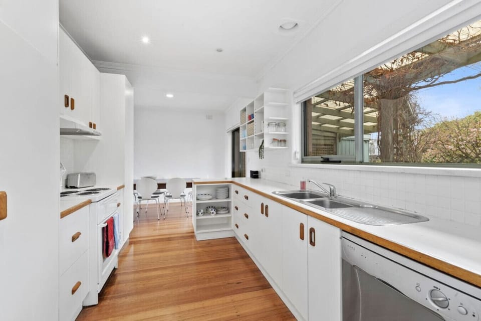 Bright, well-equipped kitchen flowing into a sunny dining area
