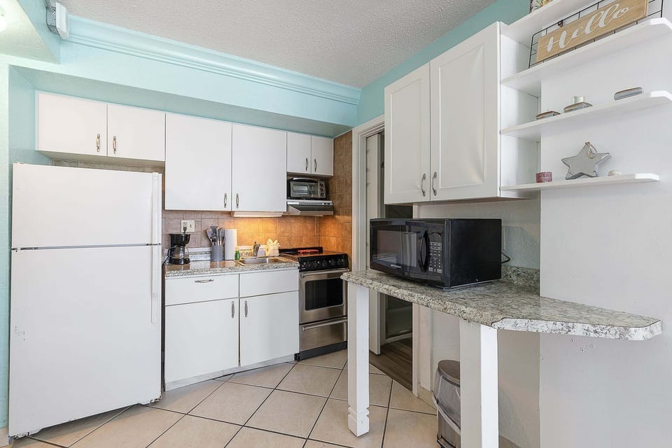 Enjoy a fully equipped coastal kitchen during your beach stay, featuring modern appliances, ample counter space, and a bright, airy design—perfect for preparing meals after a relaxing day by the ocean.